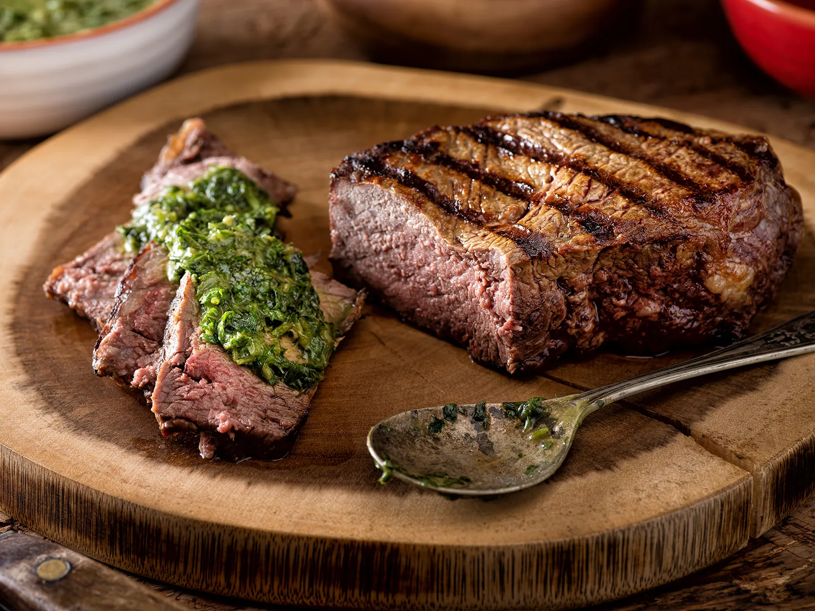 Argentine steak with chimichurri on wooden board